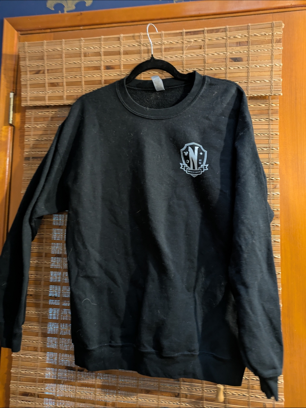 Wednesday Netflix Black Crewneck Sweatshirt with Small Shield Logo